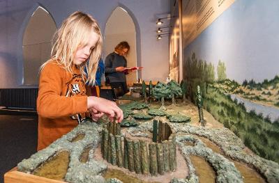 Adult and child looking at historic artefacts